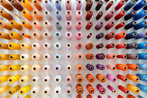 Colorful Thread Spools on a Wall